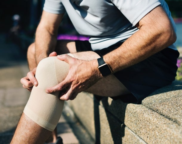 man with a bandage on his leg