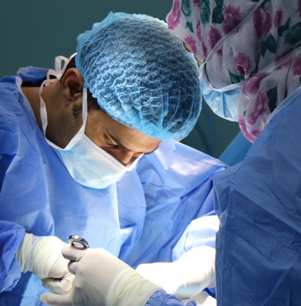 doctor performs an operation on a patient